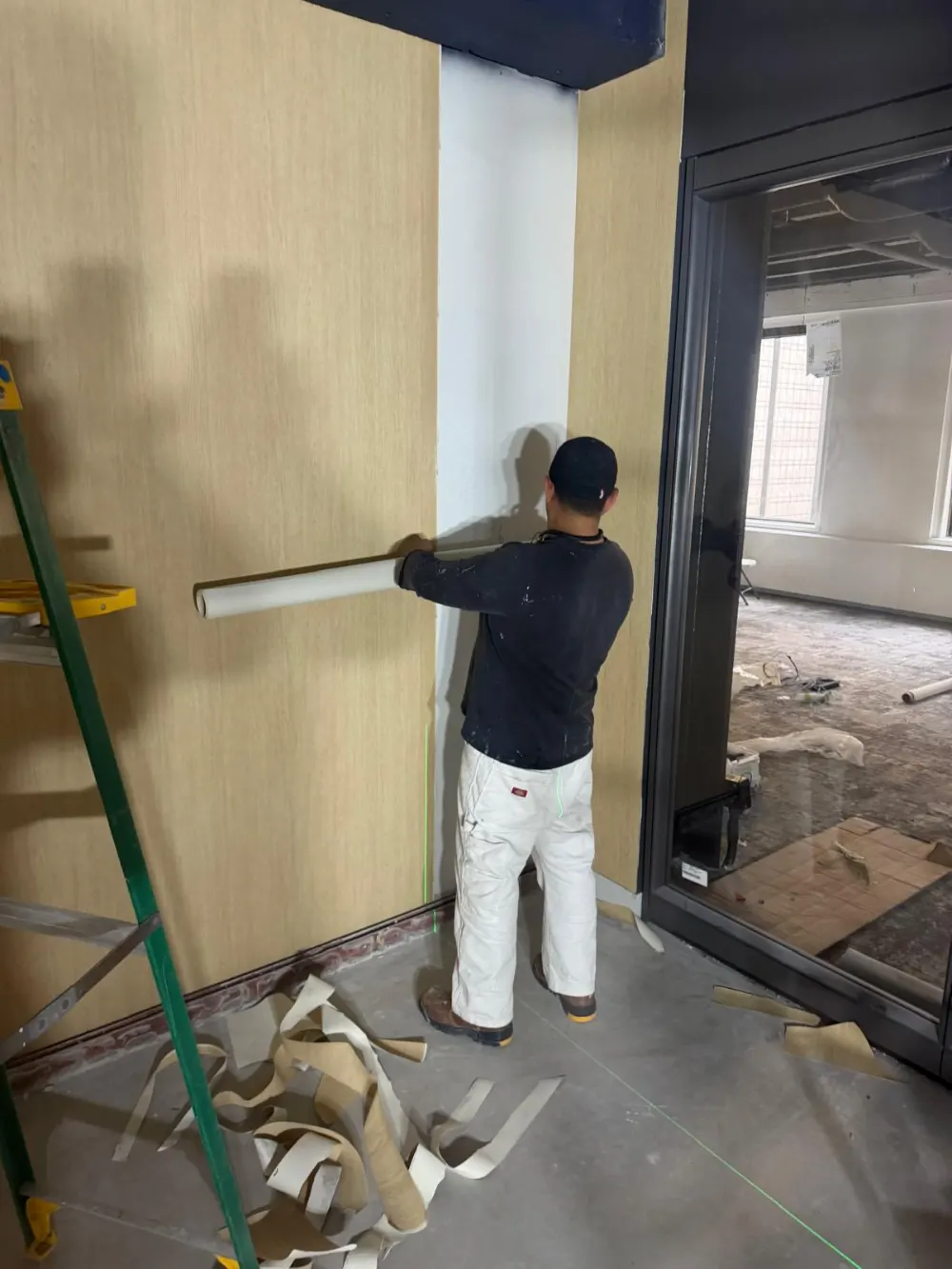 Painter preparing an interior wall before painting